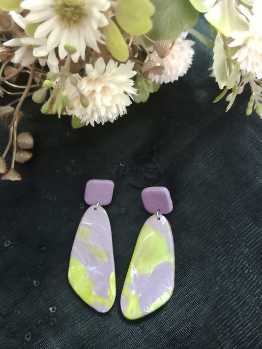 "Handcrafted Pastel Earrings with Floral Backdrop"